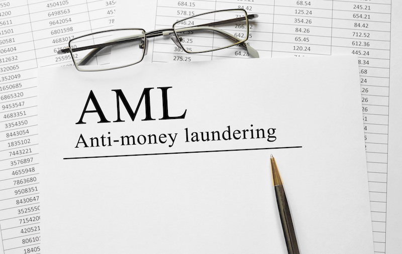 Paper with Anti-money laundering AML on a table